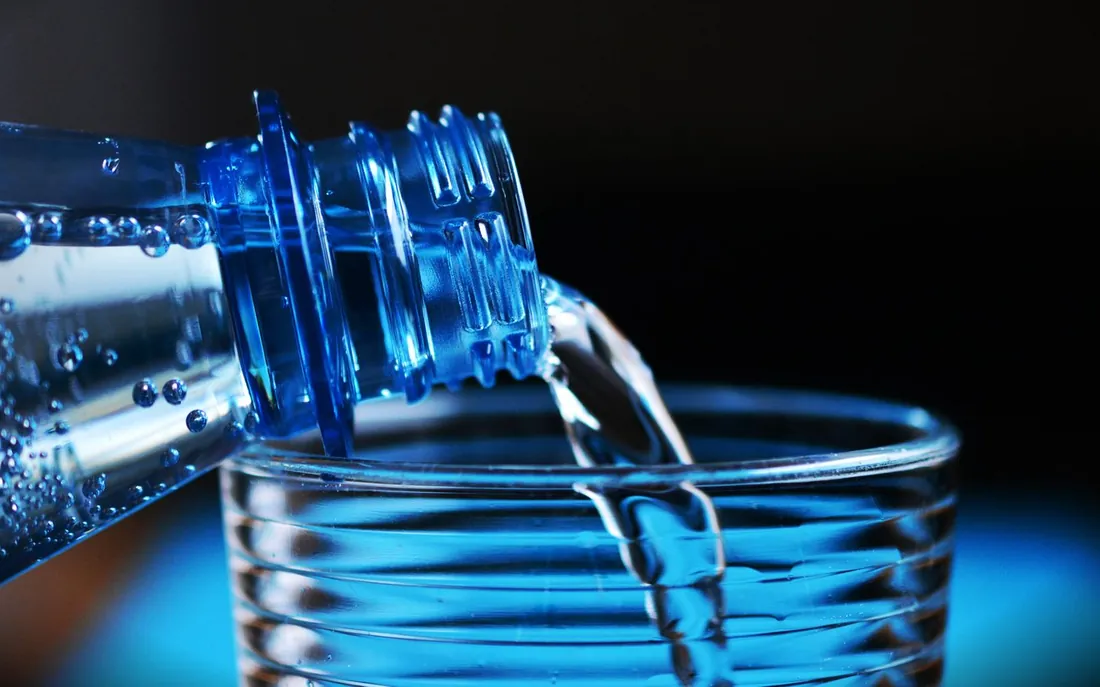 Water pouring into a glass, illustrating how water moves heat in a cooling pad